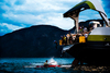 The Athletes jump out of the ferry and into the icecold water in the fjord. A kayaker is carefully looking after them and are ready to give them a hand if needed.