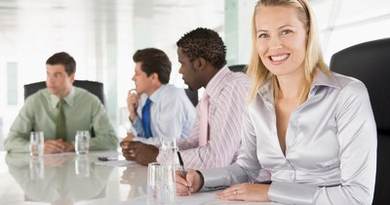 Four businesspeople in a boardroom smiling Monkey Business Images Four businesspeople in a boardroom smiling