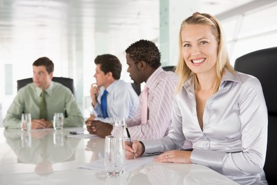 Four businesspeople in a boardroom smiling Monkey Business Images Four businesspeople in a boardroom smiling