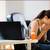 Woman Sneezing at Her Desk Woman Sneezing at Her Desk