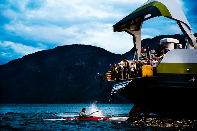 The Athletes jump out of the ferry and into the icecold water in the fjord. A kayaker is carefully looking after them and are ready to give them a hand if needed. Kai-Otto Melau The Athletes jump out of the ferry and into the icecold water in the fjord. A kayaker is carefully looking after them and are ready to give them a hand if needed.