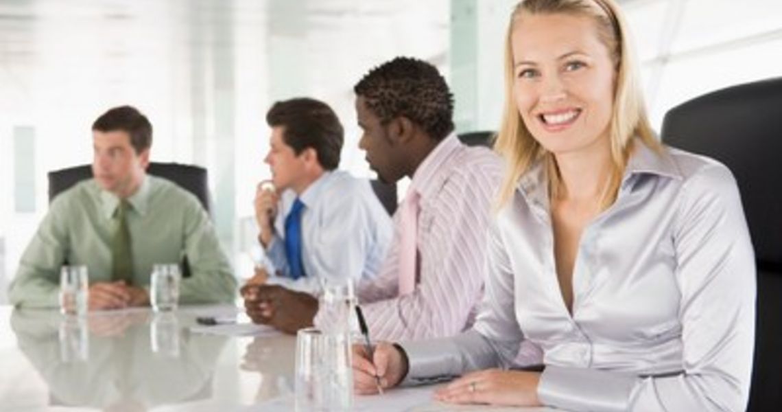 Four businesspeople in a boardroom smiling Monkey Business Images Four businesspeople in a boardroom smiling