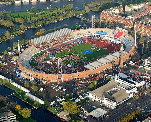 Olympisk stadion: Start og mål for Amsterdam Marathon er inne på stadion fra OL i 1928, som nå er ombygd og skal være arena for neste års EM i friidrett. Det er starten for maraton som er i gang på bildet og vi ser løpere på vei ut maratonporten ved stadiontårnet.