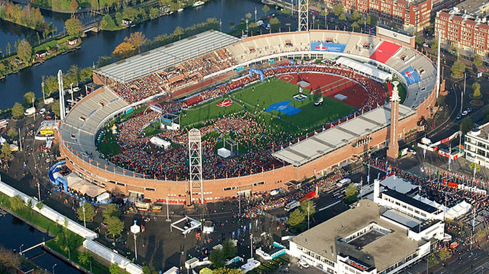 Olympisk stadion: Start og mål for Amsterdam Marathon er inne på stadion fra OL i 1928, som nå er ombygd og skal være arena for neste års EM i friidrett. Det er starten for maraton som er i gang på bildet og vi ser løpere på vei ut maratonporten ved stadiontårnet.