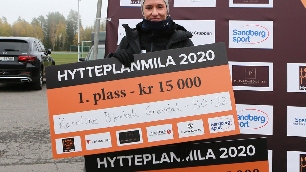 Karoline Bjerkeli Grøvdal kunne ta imot 4 sjekker på tilsammen 85 000 kroner etter rekordløpet i Hytteplanmila. 15000 for seier, 25000 for løyperekord, 25000 for norsk bestenotering og 20000 i en spesiell prestasjonspris. (Foto: Kjell Vigestad)