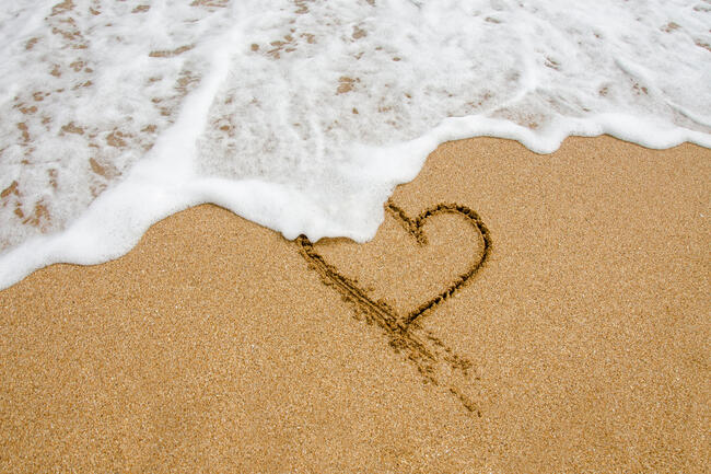Shape of the heart in the sand on the beach