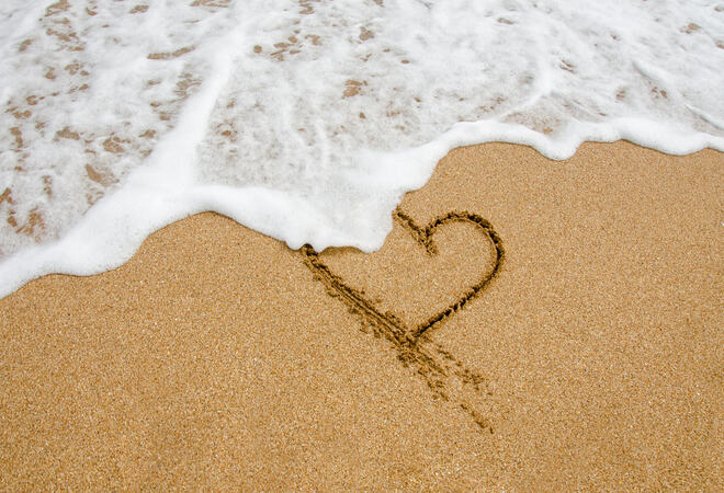 Shape of the heart in the sand on the beach