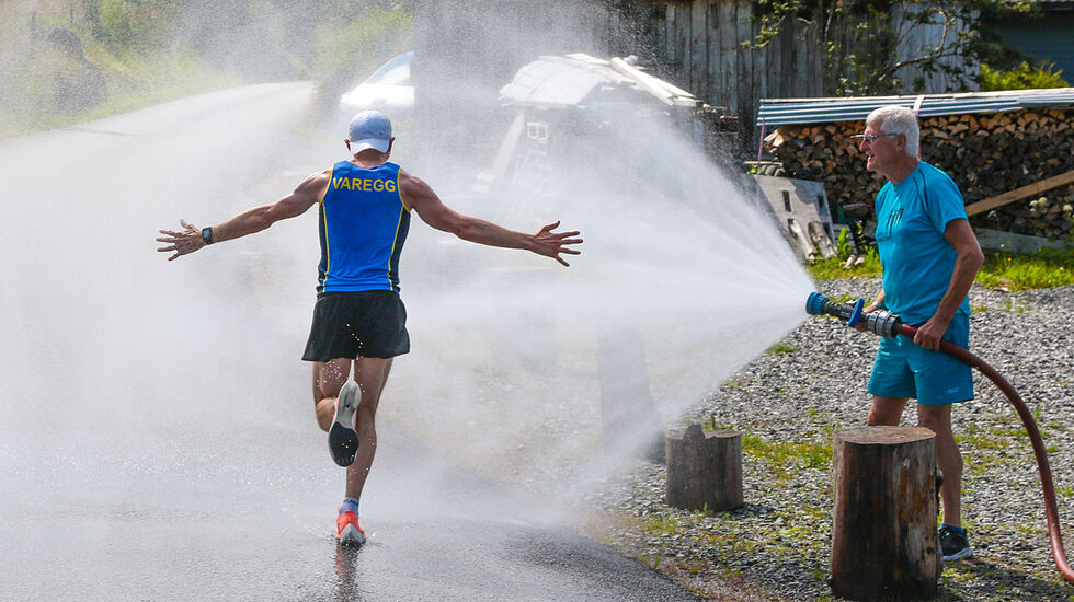 Tage Morken Augustson får en avkjølende dusj med vann fra Jølstravatnet, på vei mot mål og seier på halvmaraton. (Foto: Arne Dag Myking)