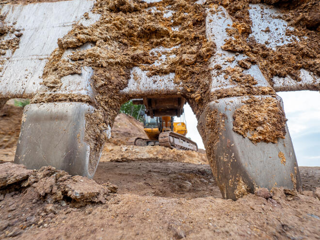 Detailed steel teeth of excavator bucket. Scarry  bucket teeth.