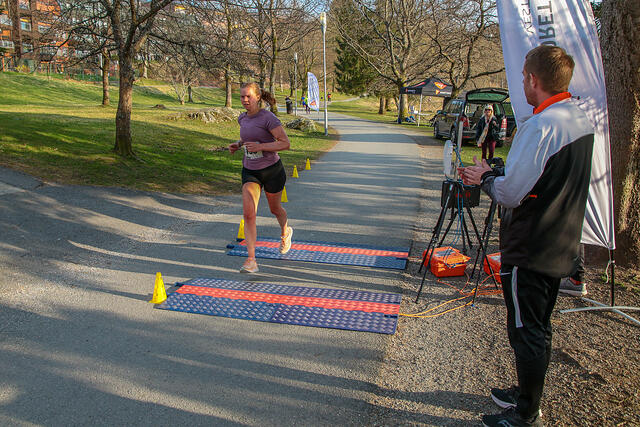 Caroline Thorvik Olsen løper i mål som beste kvinne på 10 km. Christian Jensen i Bedriftsidretten Vestland heier henne inn. (Alle foto: Arne Dag Myking)