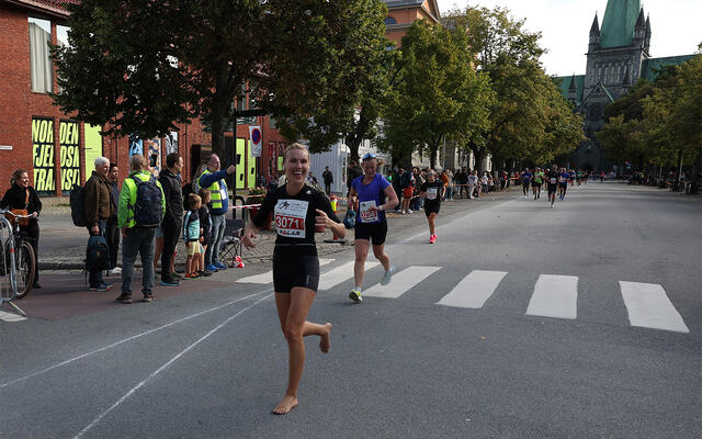 De nakne beina tok Christina Forstrønen Bruarøy trygt til mål – med et smil om munnen og Nidarosdomen i bakgrunnen. (Foto: Marianne Røhme)