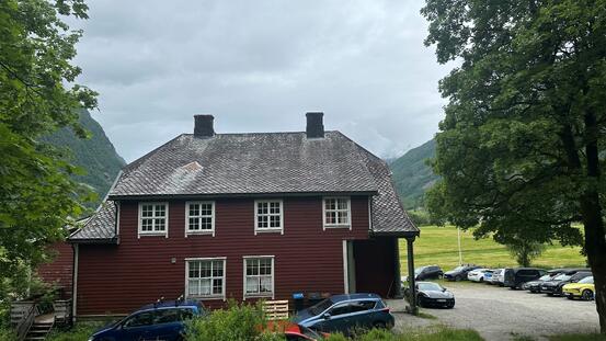 Fjærland bygdahus. (Foto: Anja Hamre) Stor raud byging med valma tak.
