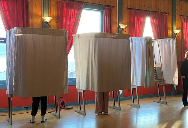 To vallavlukke med personar i, eitt ope.
